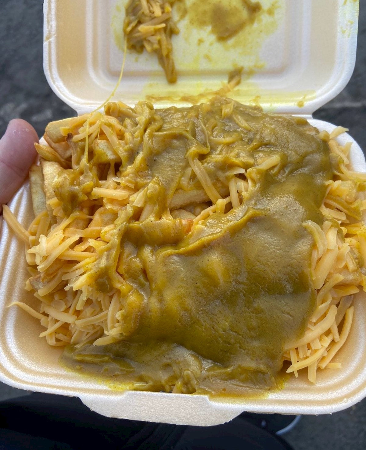 Chips, cheese, and curry sauce
