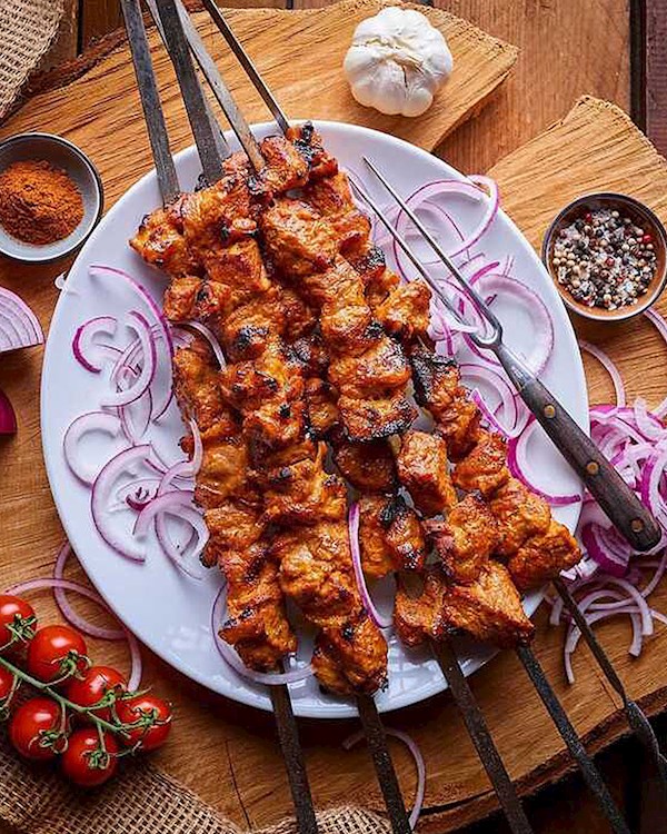 Grilling marinated shashlik on a grill. Shashlik is a form of Shish kebab  popular in Eastern, Central Europe and other places. Shashlyk meaning skewer  Stock Photo - Alamy